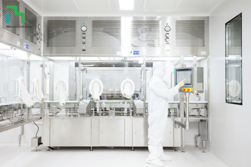 A person in a white lab coat working in a laboratory

Description automatically generated with low confidence